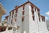 Ladakh - Lamayuru Gompa, the main monastery halls with the characteristc red painted windows and woden balconies on white washed faades 